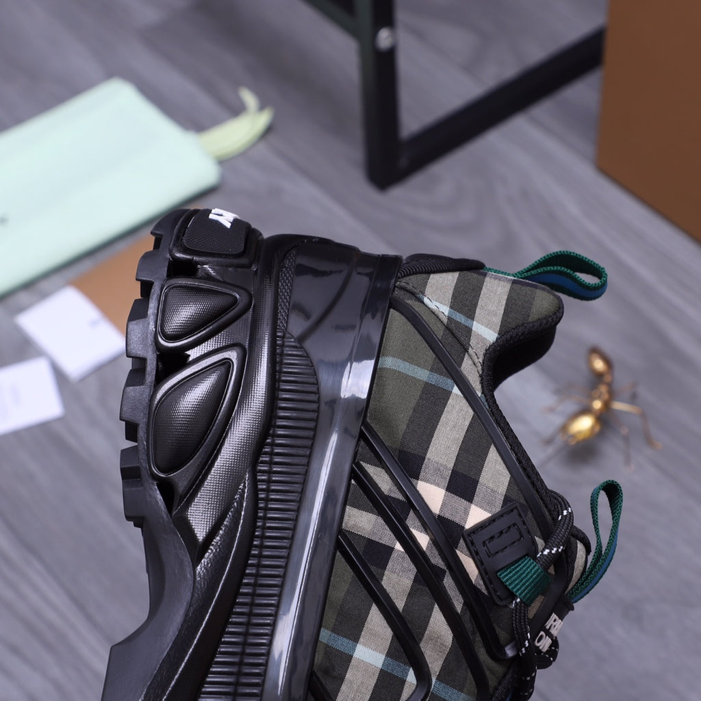 Burberry chunky sneakers, black with check fabric inserts and teal lace accents, side view