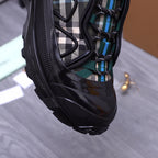 Burberry chunky sneakers, black side with plaid panel and teal lace trim, close-up
