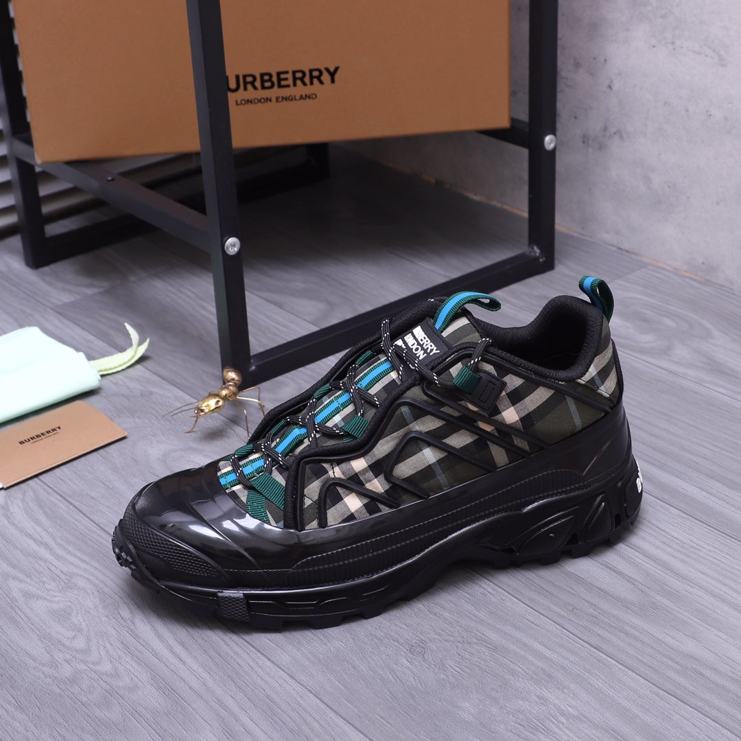Burberry chunky sneakers, black with teal accents and check-pattern upper, side view