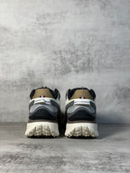 Moncler trail sneaker heel view, white and dark panels with chunky tread