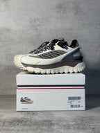 Moncler trail sneaker on shoebox, white upper with navy stripe and black laces