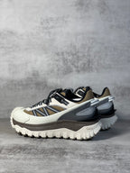 Moncler trail sneaker, low side angle, white base with navy stripe and gray trim