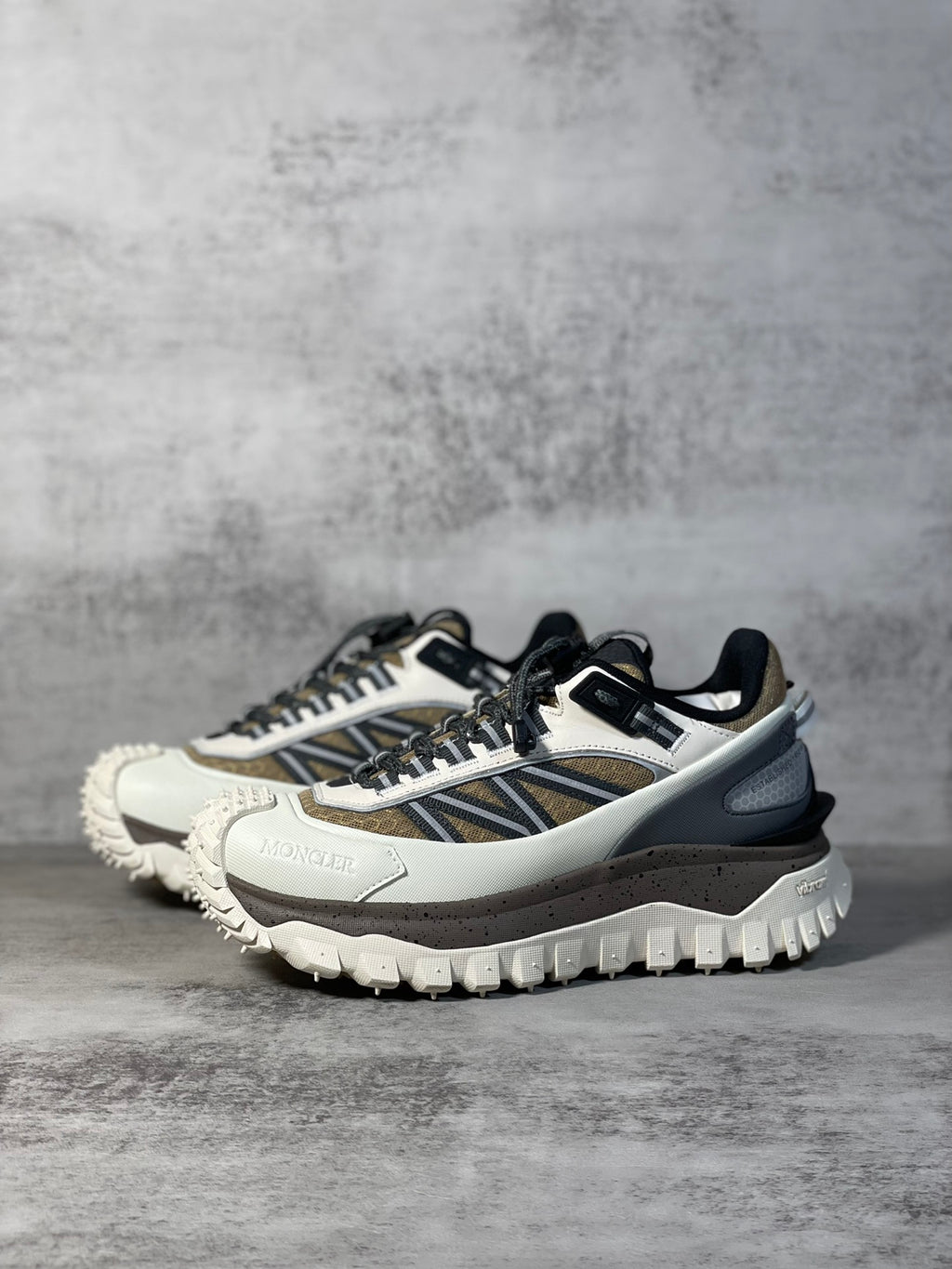 Moncler trail sneaker, front 3/4 view, white leather-look with navy and black details