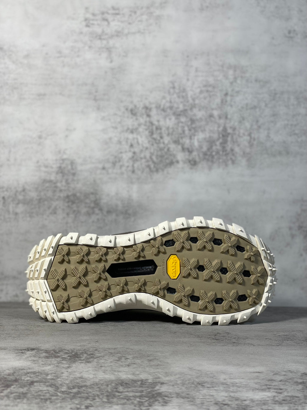 Moncler trail sneaker outsole view with patterned tread and rubber traction lugs