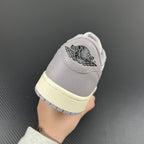 Heel of low-top sneakers in gray with stitched “AIR” logo and cream midsole.