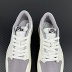 Pair of white low-top sneakers with lace-up closure and gray insole branding.
