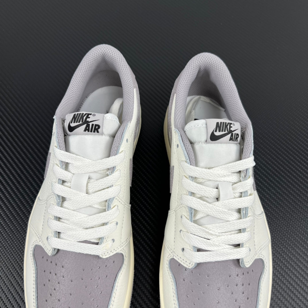 Pair of white low-top sneakers with lace-up closure and gray insole branding.