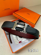 Leather belt with dark front strap and silver rectangular H buckle