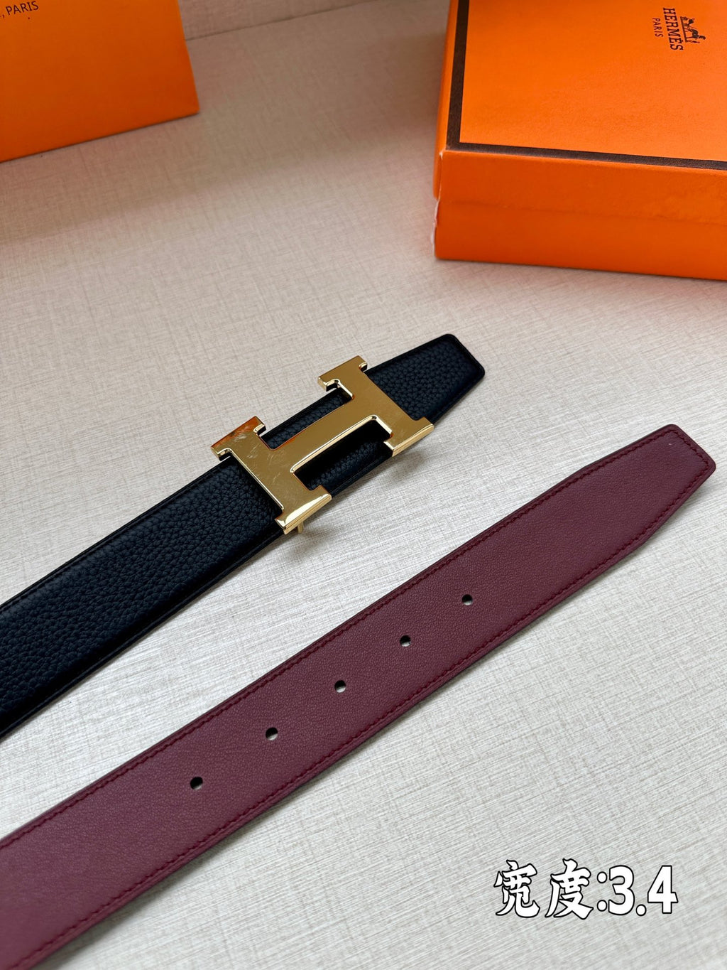 Leather belt with gold-tone H buckle; dark and burgundy straps shown