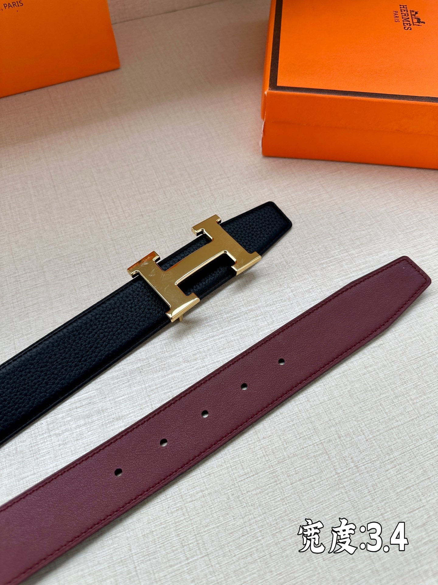 Leather belt with gold-tone H buckle; dark and burgundy straps shown