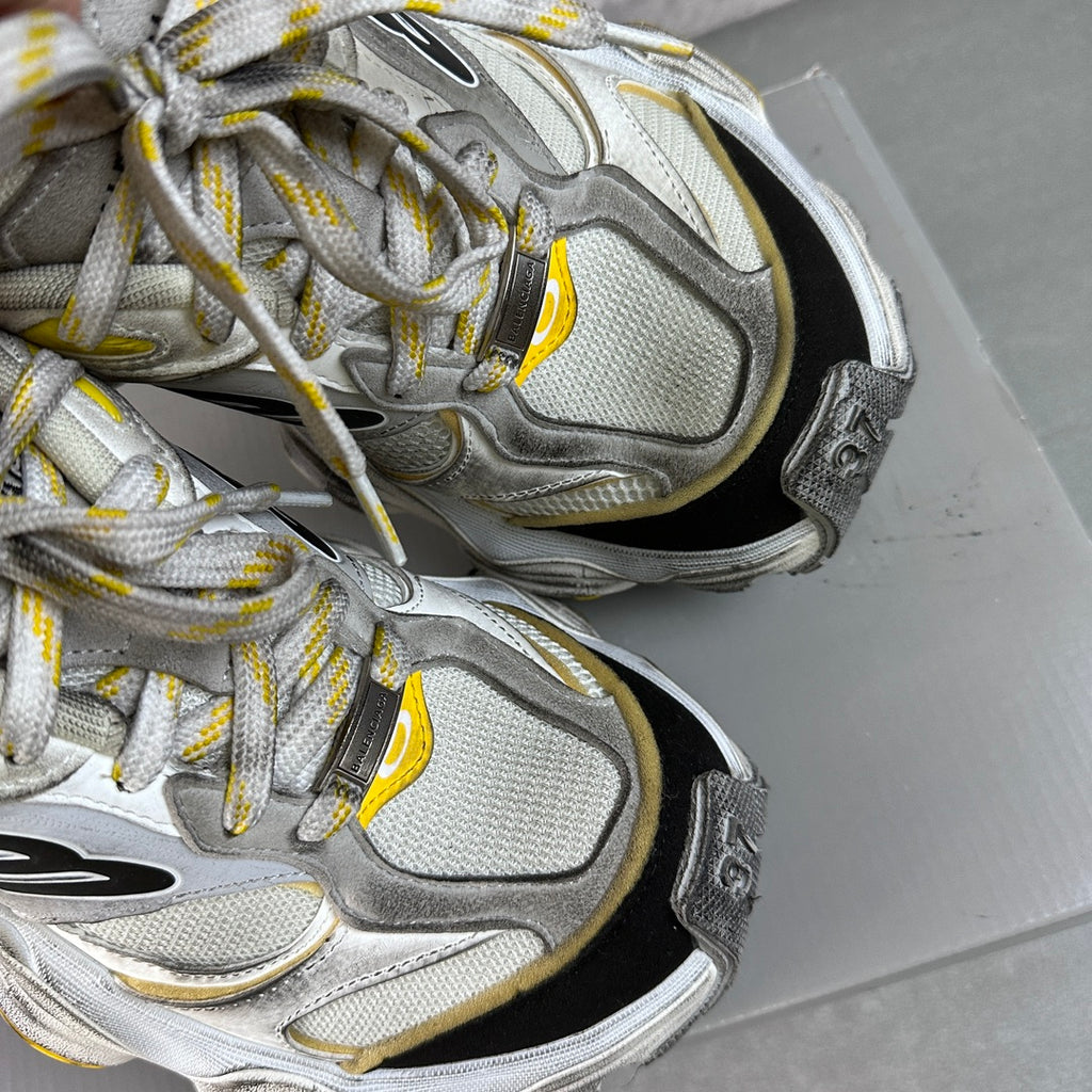 Balenciaga unisex sneakers close-up on toe and laces, silver-gray knit with yellow piping