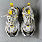 Balenciaga unisex sneakers pair view, silver-gray uppers with yellow lace loops and black heel