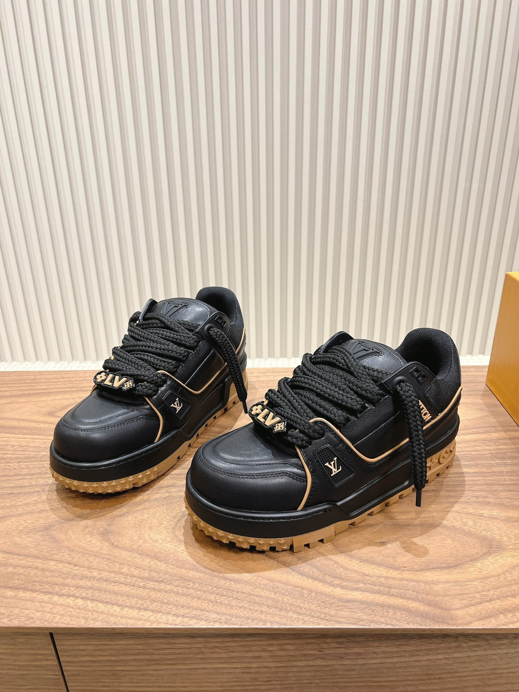 Black Louis Vuitton trainer sneakers with laces and tan lug soles, side view