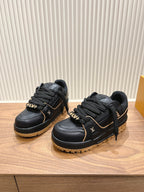 Black Louis Vuitton trainer sneakers with laces and tan lug soles, side view