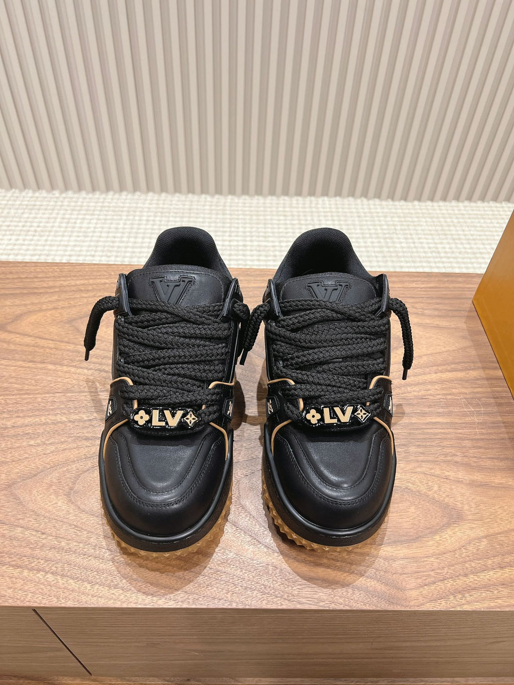 Black trainer sneakers with laces, LV heel logos, tan lug soles