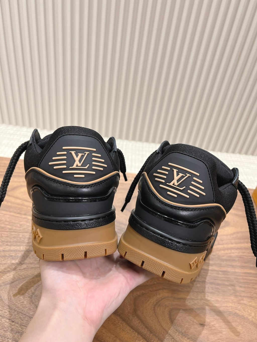 Black trainer sneakers with LV back emblem and tan lug soles