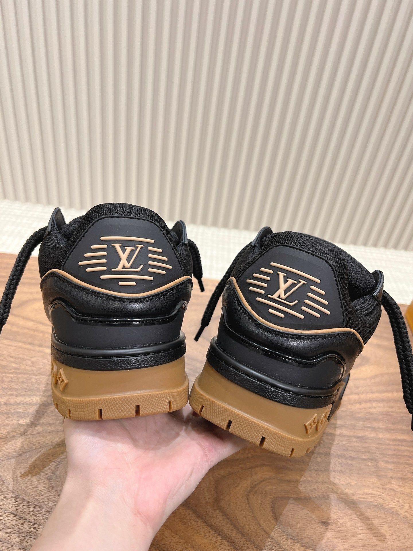 Black trainer sneakers with LV back emblem and tan lug soles