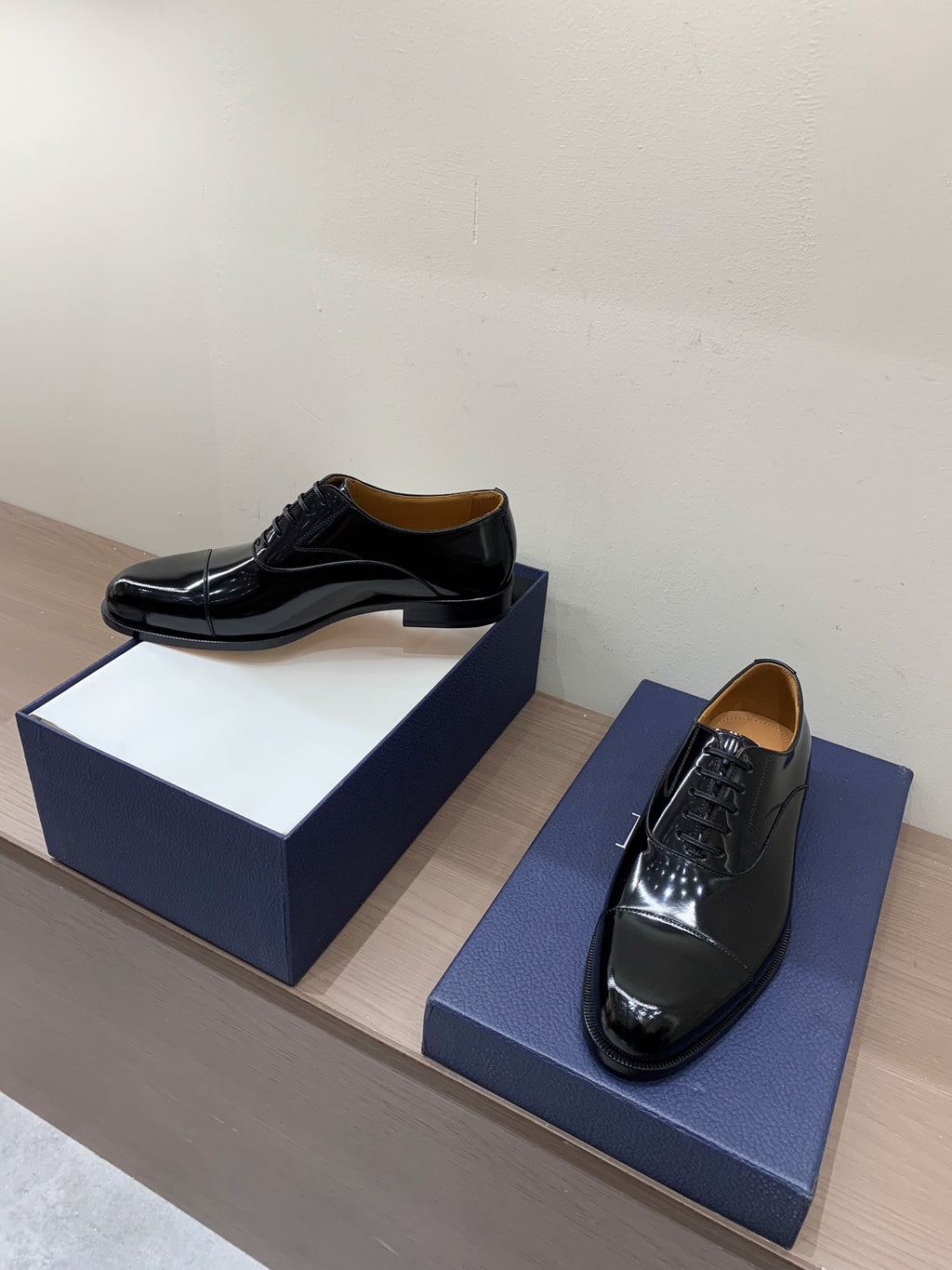 Dior unisex lace-up Oxford shoes in black patent leather, shown with boxes
