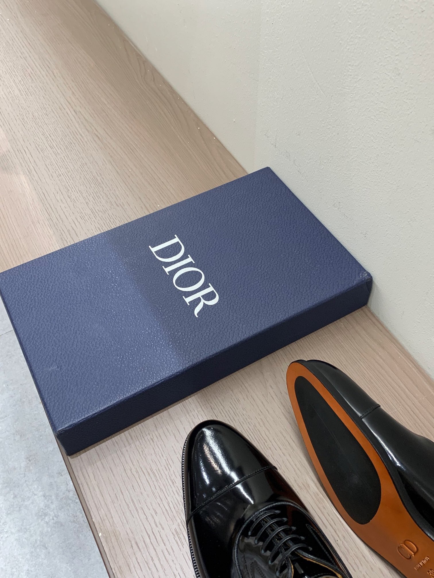 Dior unisex lace-up Oxford shoes in black patent leather, with shoe close-up