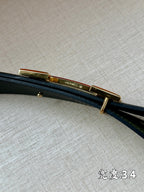 Green leather belt with gold-tone bar buckle, side view