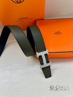 Green leather belt with metallic H buckle and loop keeper