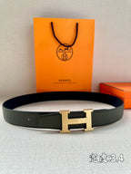 Green leather belt with gold-tone H buckle and keeper loop