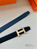 Dark blue Hermes belt with gold-tone H buckle and several adjustment holes