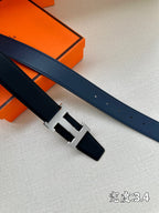 Hermes belt end and buckle detail in dark blue leather with gold-tone H