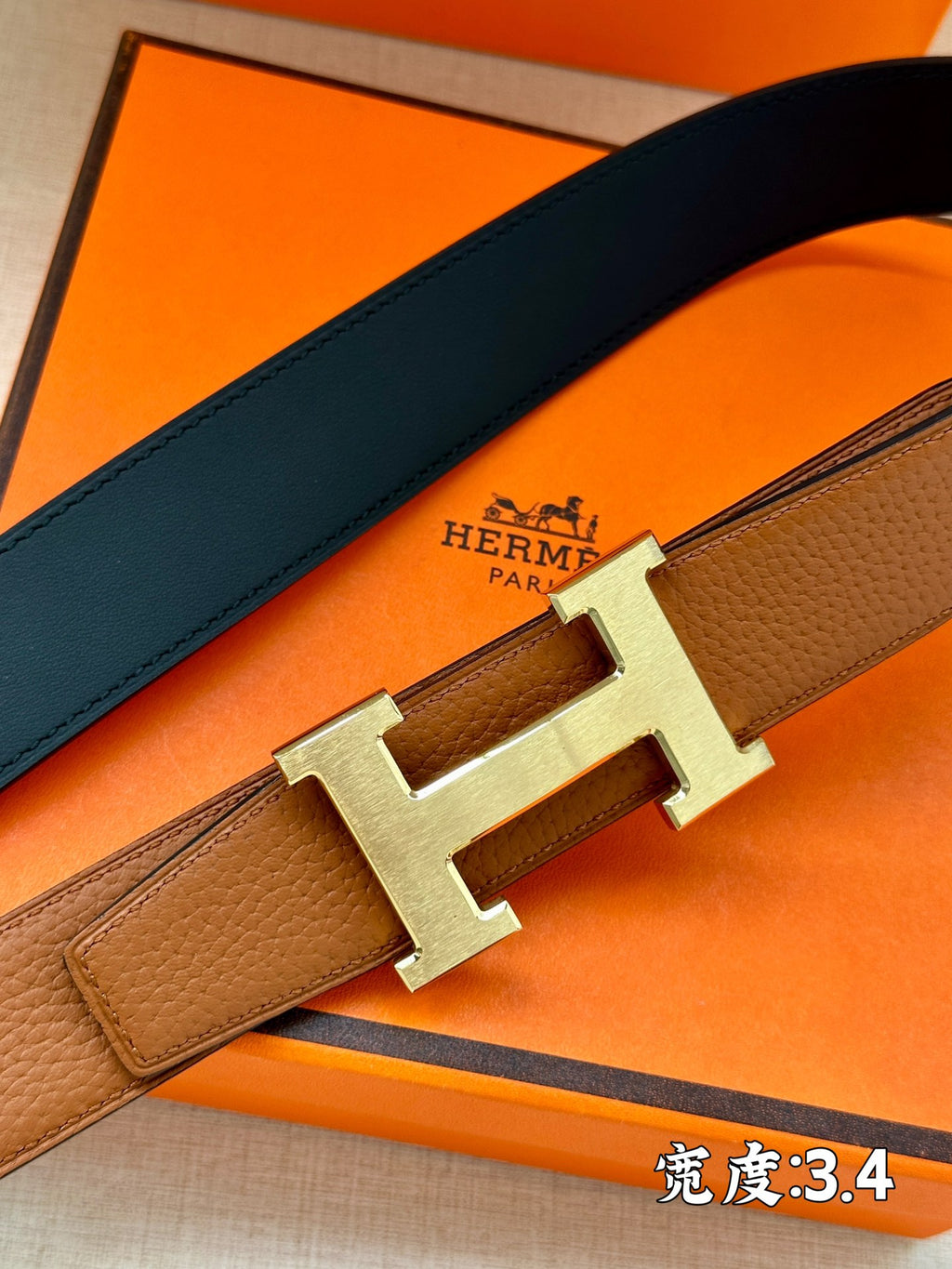 Brown leather belt with silver H buckle, clasp detail