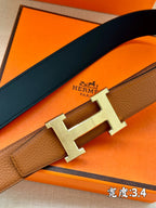 Brown leather belt with silver H buckle, clasp detail