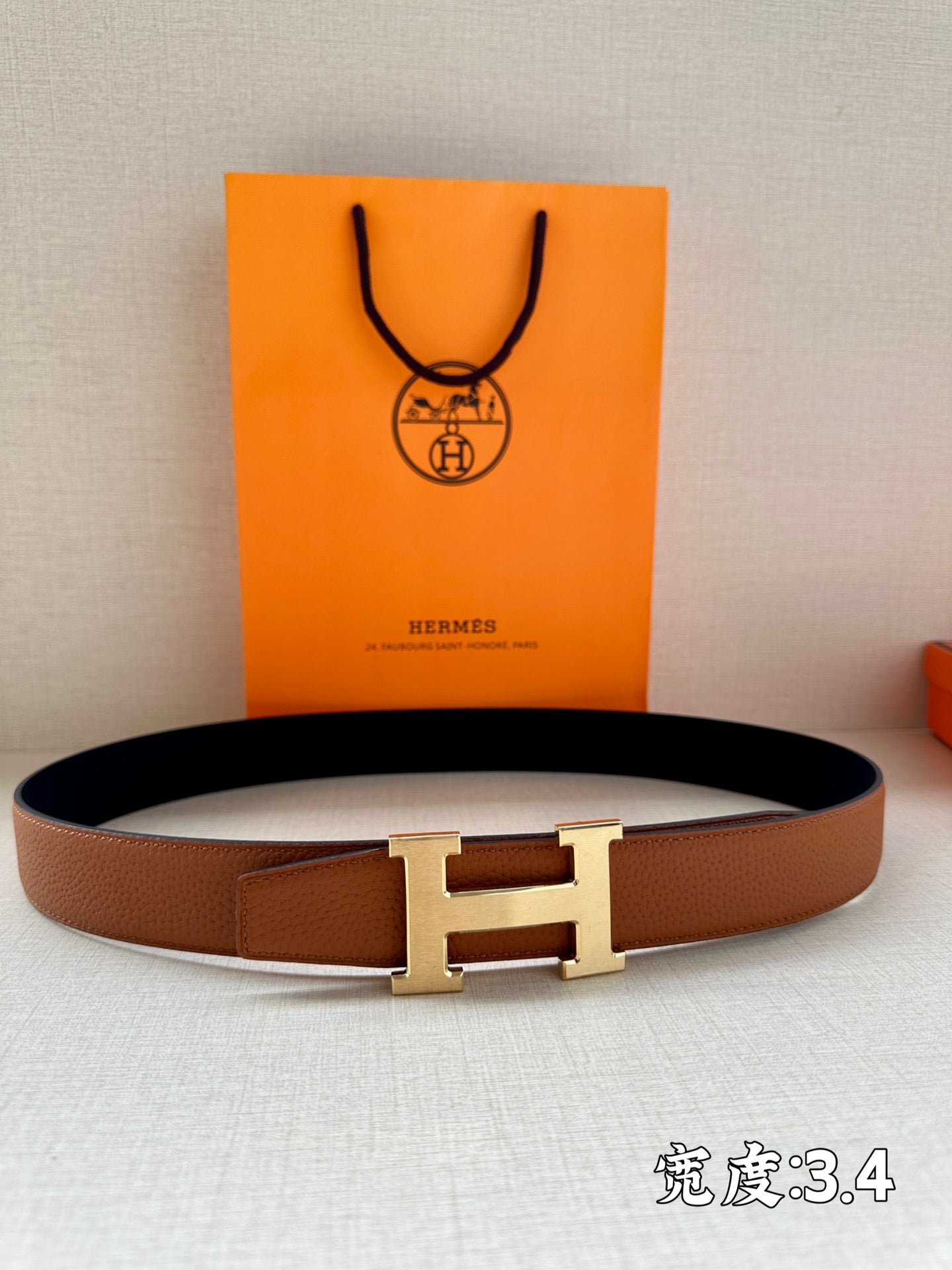 Leather belt with silver H-style buckle and brown strap