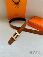 Brown leather belt with silver H buckle, laid flat