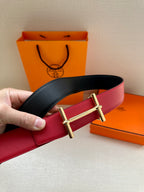 Reversible belt with black and red leather straps and gold-tone double-prong buckle.