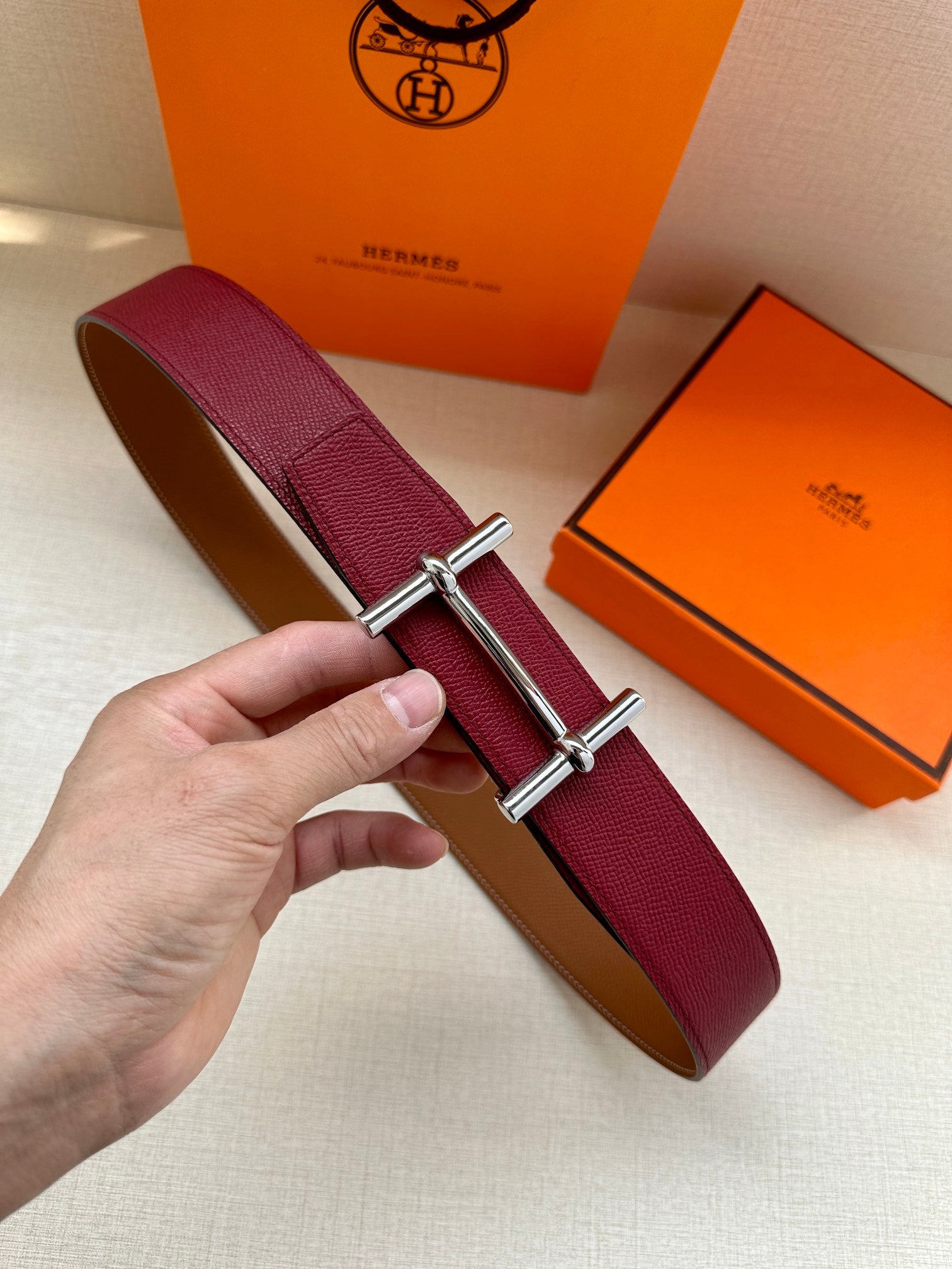 Hermes leather belt with burgundy strap and polished silver H buckle