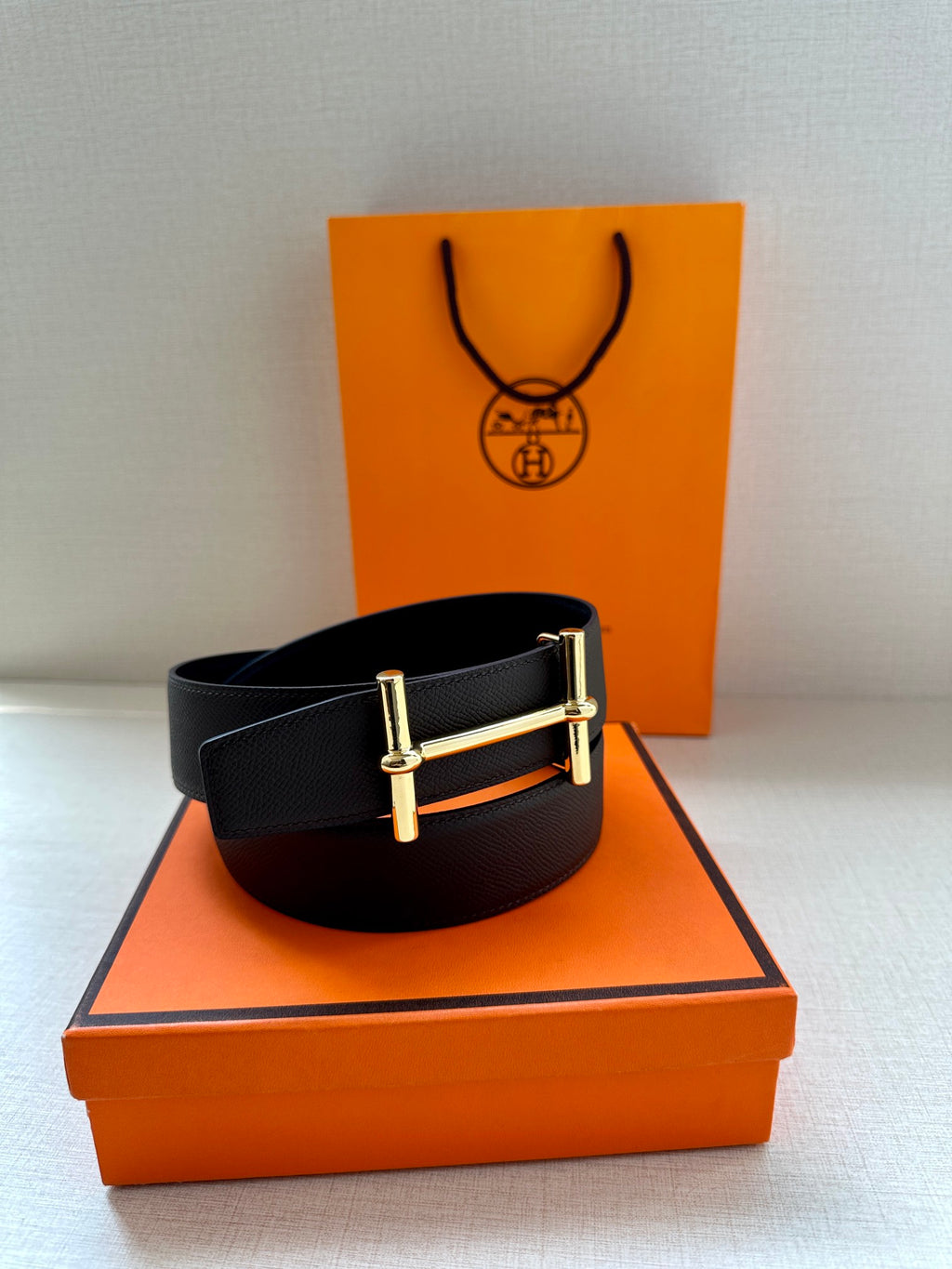 Hermes belt black textured leather with gold-tone rectangular buckle.