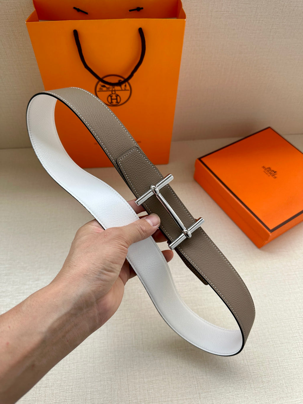 Taupe and white leather belt with silver-tone double-prong buckle