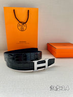 Hermes belt with dark crocodile-texture leather and silver rectangular H buckle.