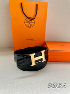 Hermes belt in dark crocodile-texture leather with silver H buckle.
