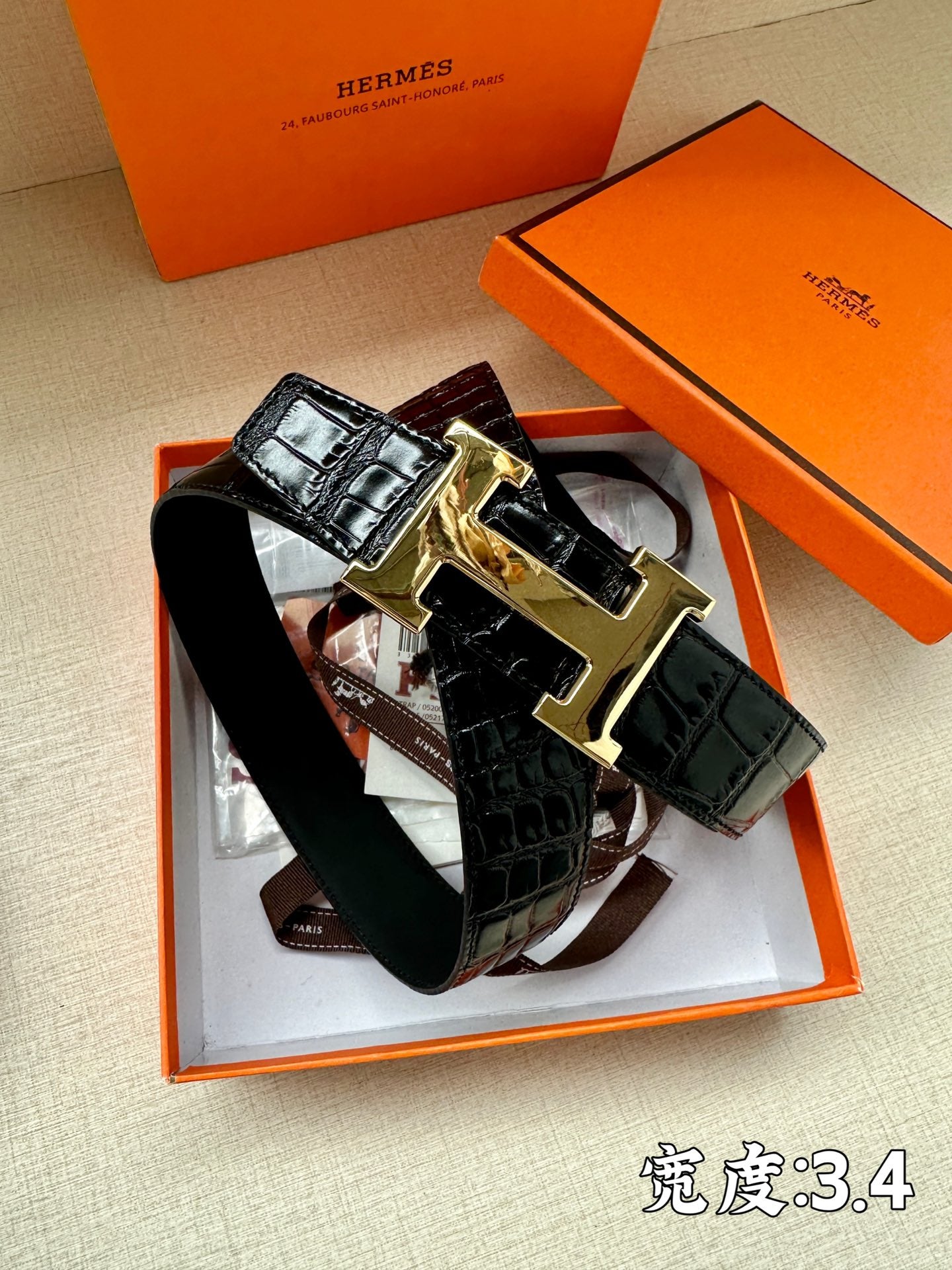 Hermes belt in dark crocodile-style leather with gold-tone buckle, front view