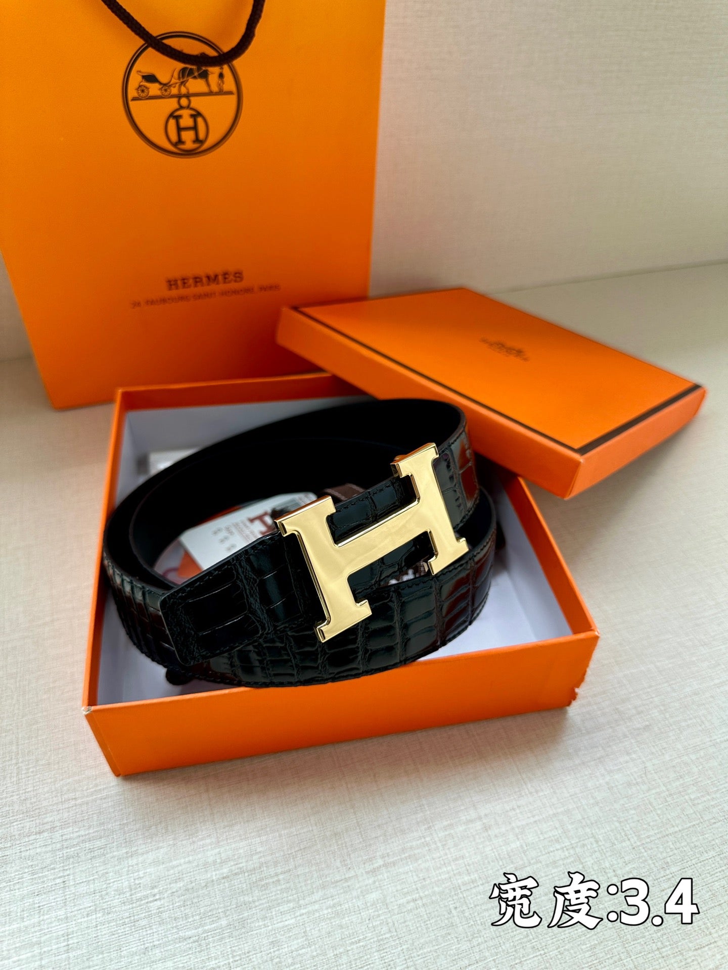 Hermes belt in dark embossed leather with gold-tone H buckle in gift box