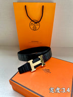 Hermes belt in dark embossed leather with silver H buckle on boxed display
