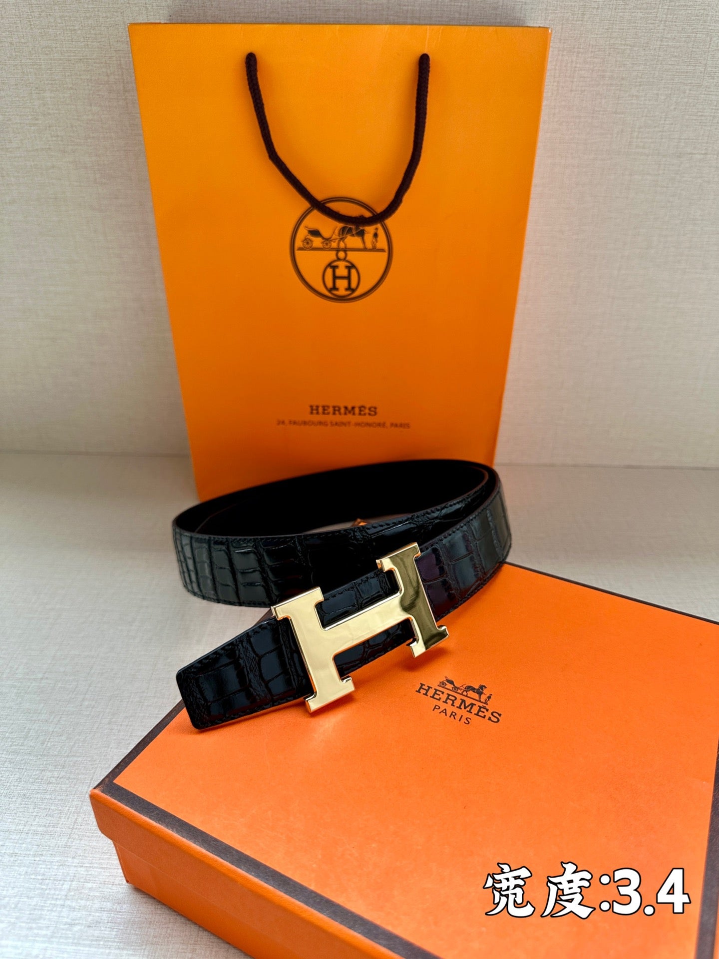 Hermes belt in dark embossed leather with silver H buckle on boxed display
