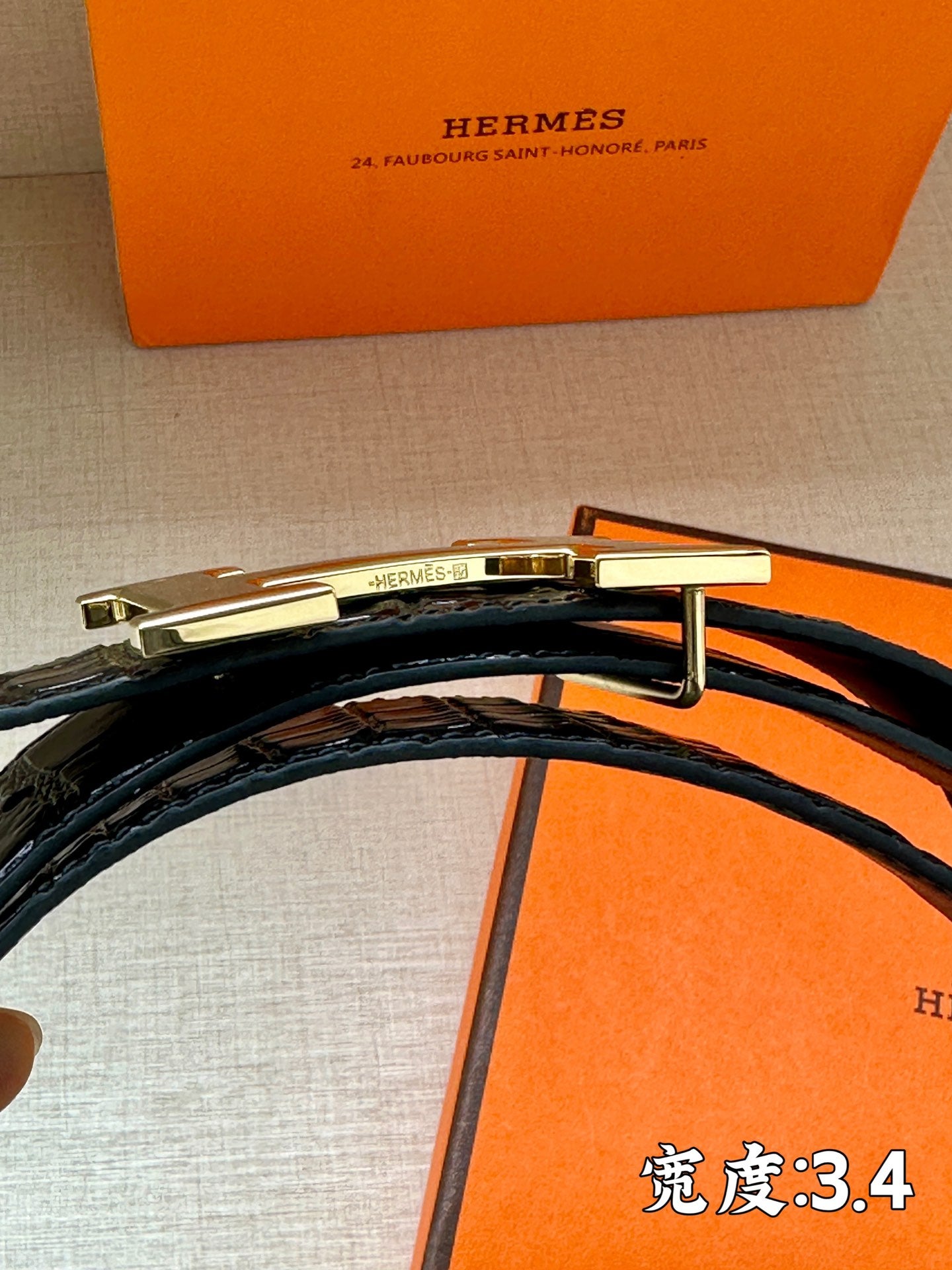 Hermes belt strap shown with metal H hardware detail and dark embossed leather