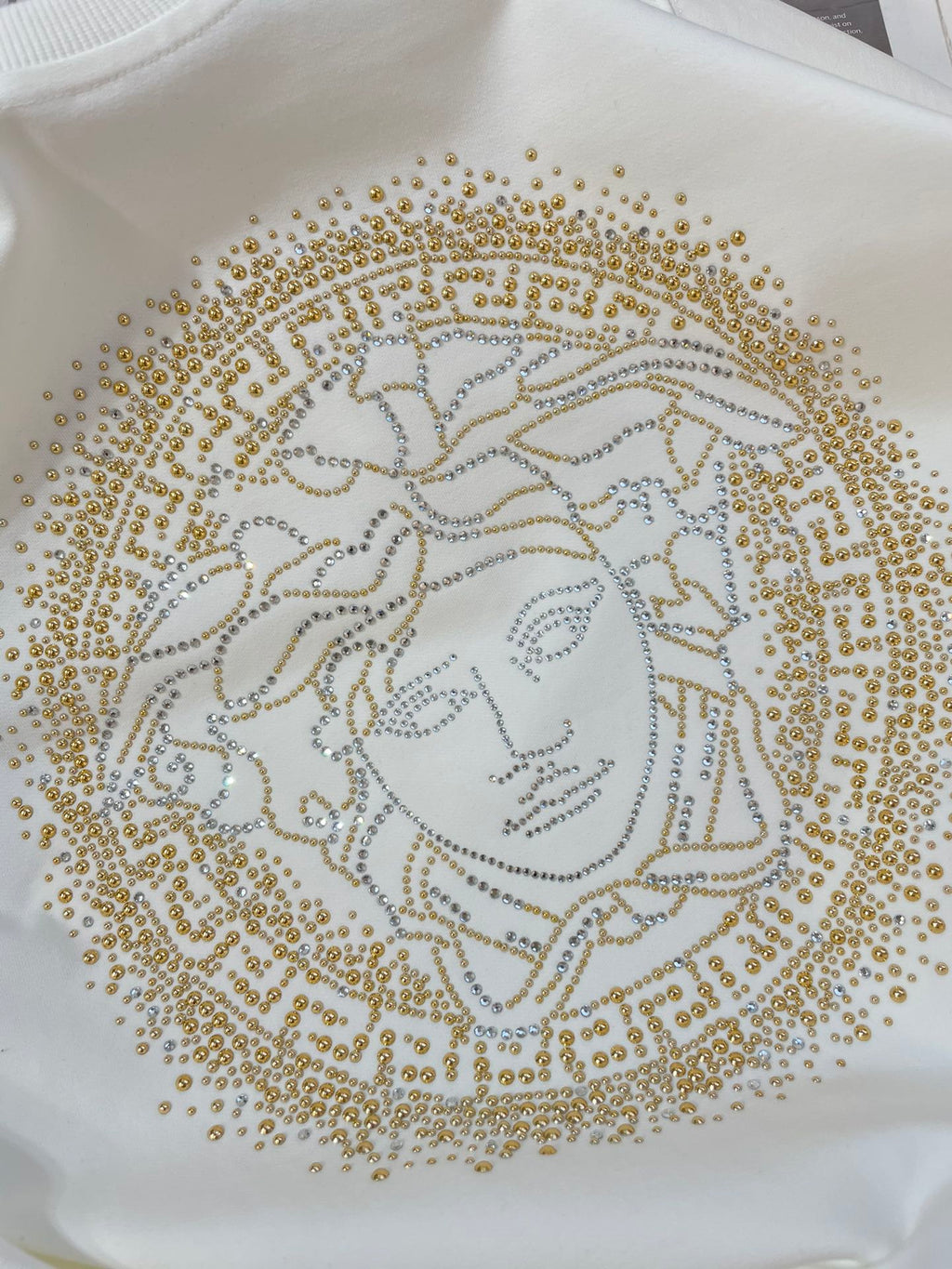 Versace white sweatshirt with close-up gold Medusa face beadwork print