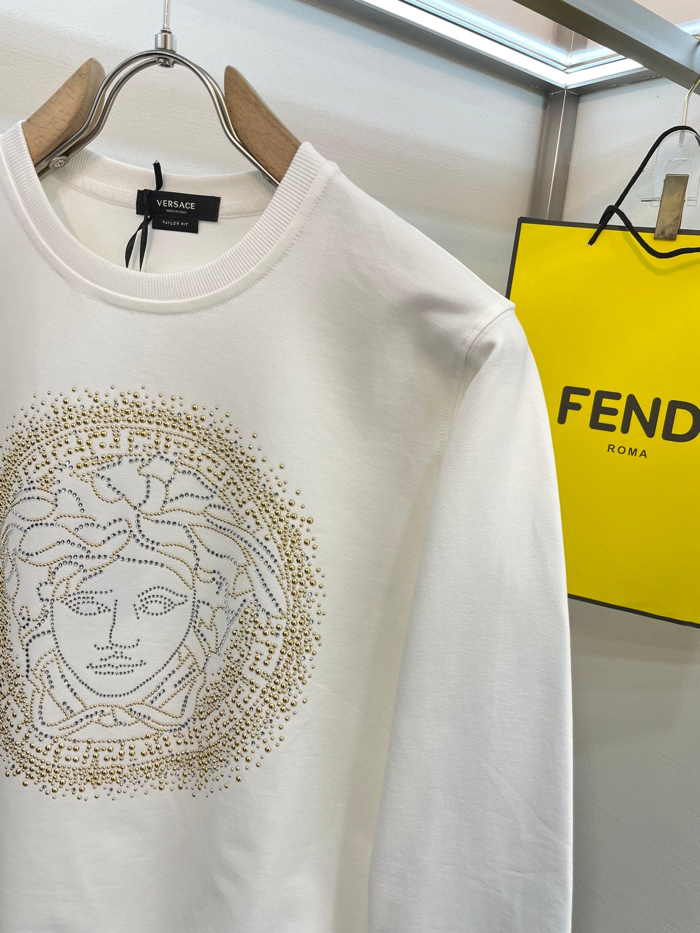 Versace white crewneck sweatshirt with gold Medusa face logo on front