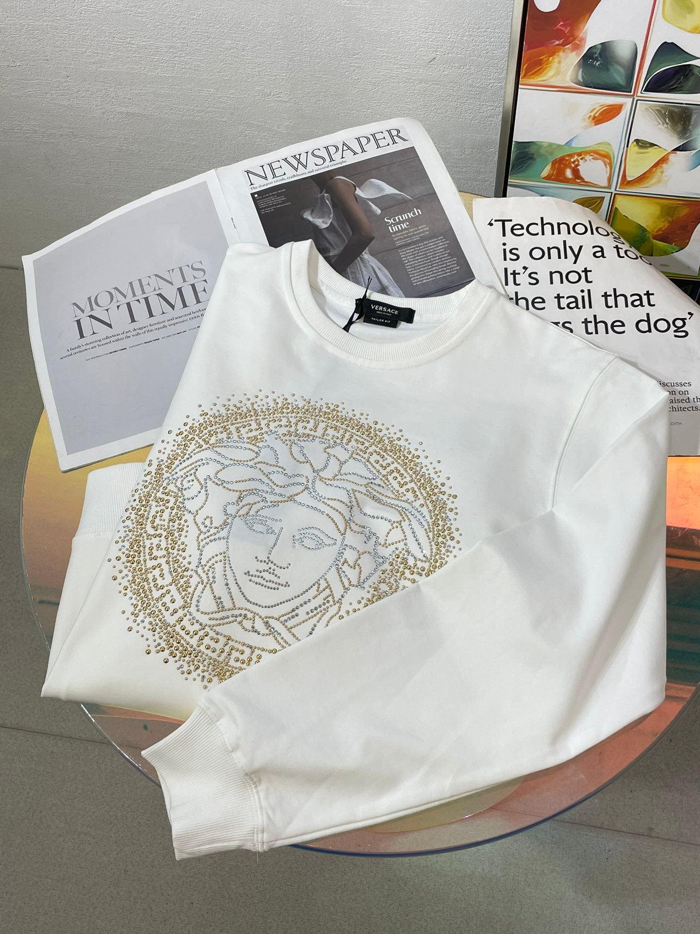 Versace white sweatshirt with gold Medusa face graphic on chest