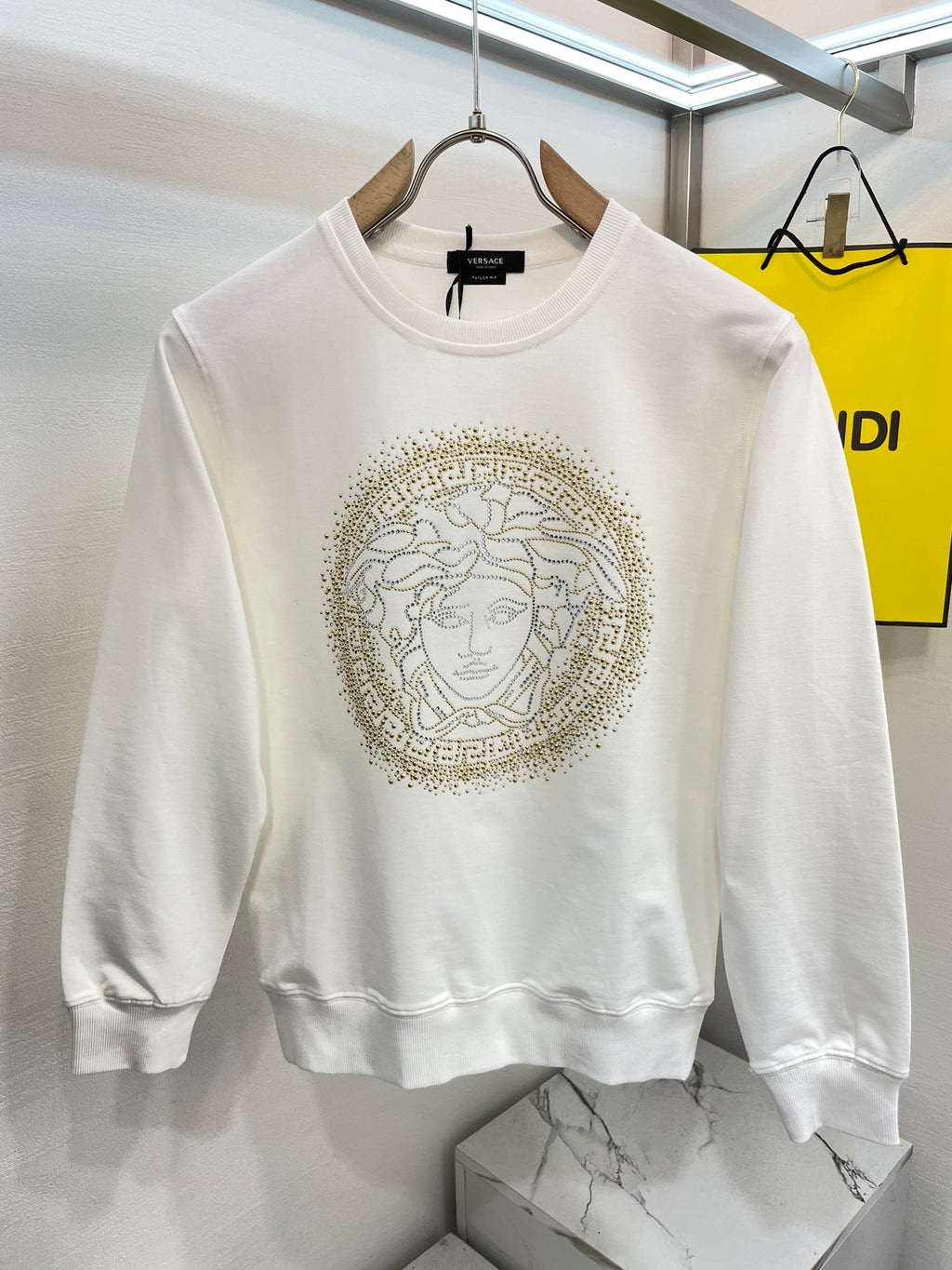 Versace white crewneck sweatshirt with gold Medusa face emblem on chest