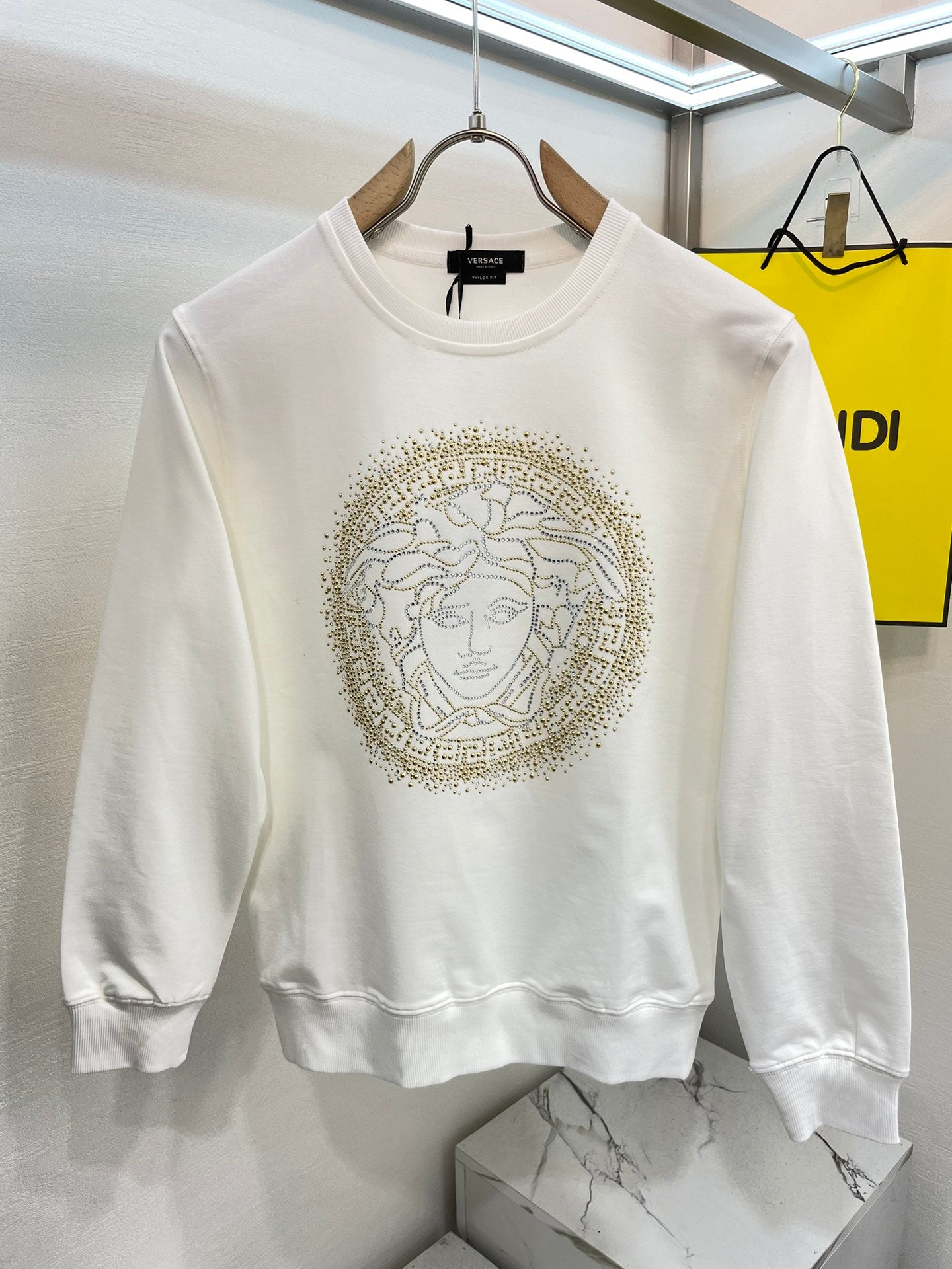 Versace white crewneck sweatshirt with gold Medusa face emblem on chest
