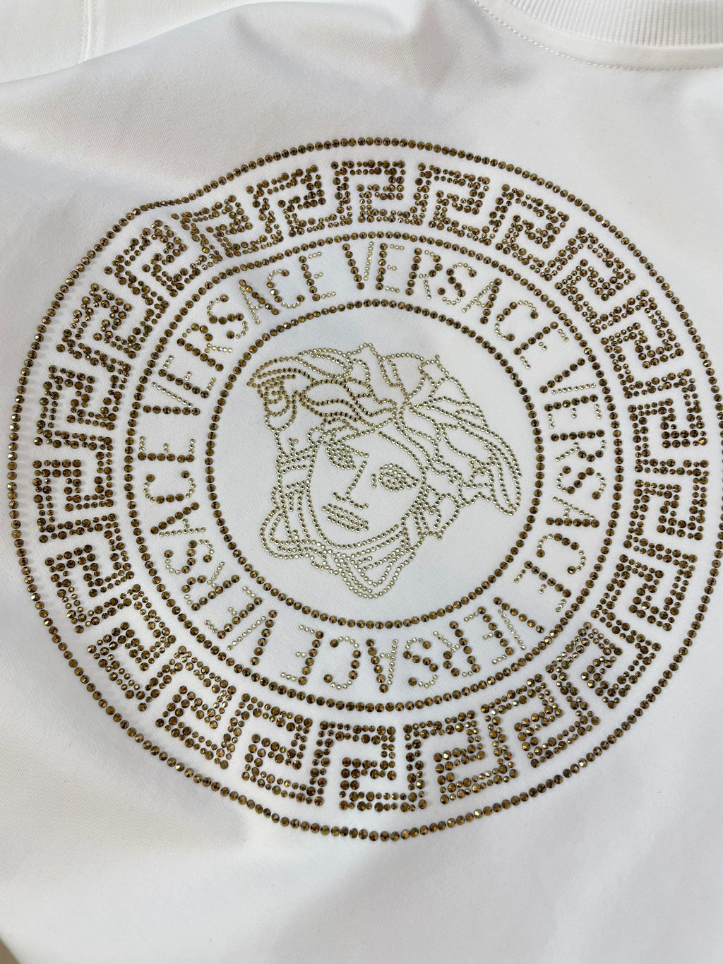 White crewneck sweatshirt with gold bead medallion lion logo print