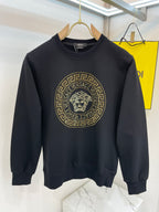 Black crewneck sweatshirt with gold medallion lion logo on front